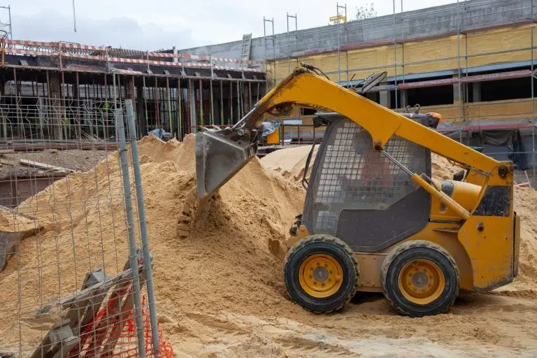 compact wheel loader moving dirt