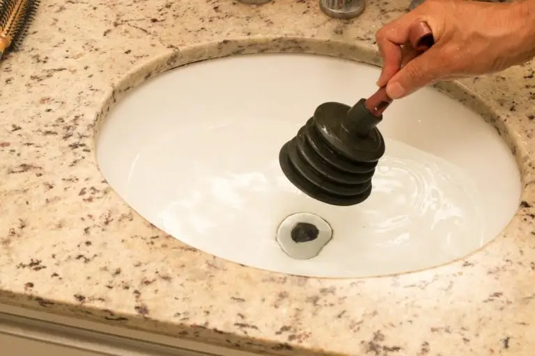 plunger in use on bathroom sink